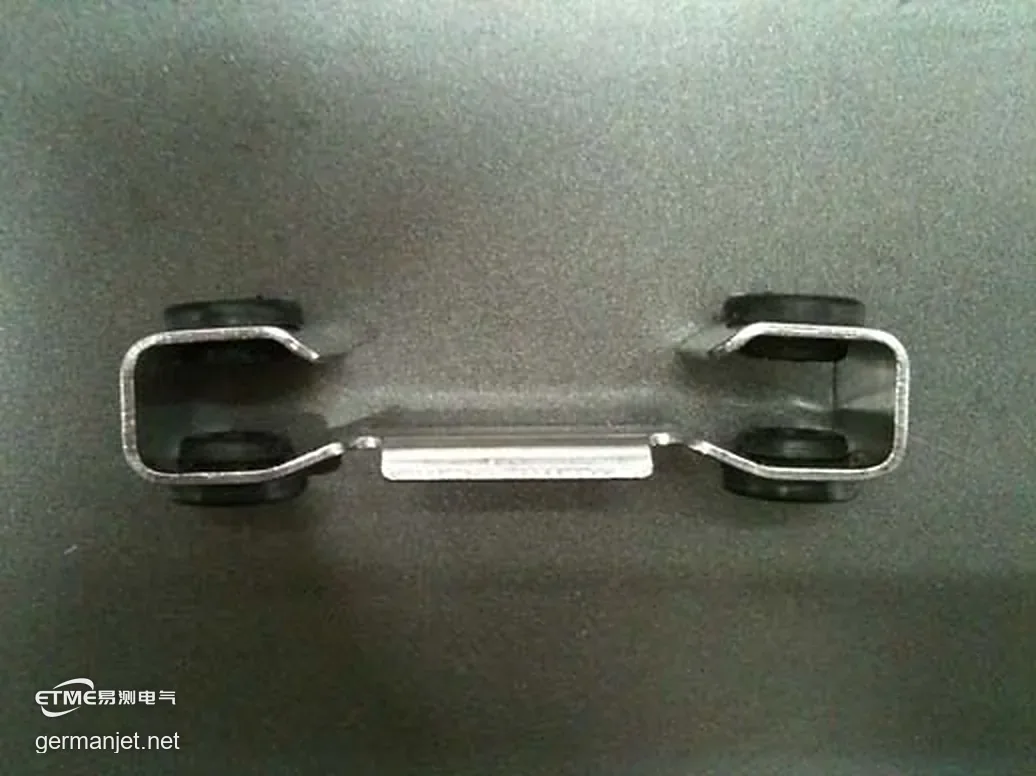 Removed anti-vibration clip with undamaged black elastomer