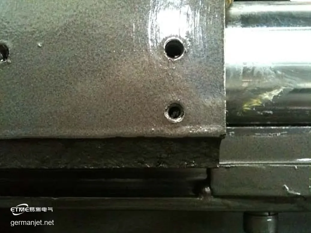 Two mounting holes on the machine, both fully threaded